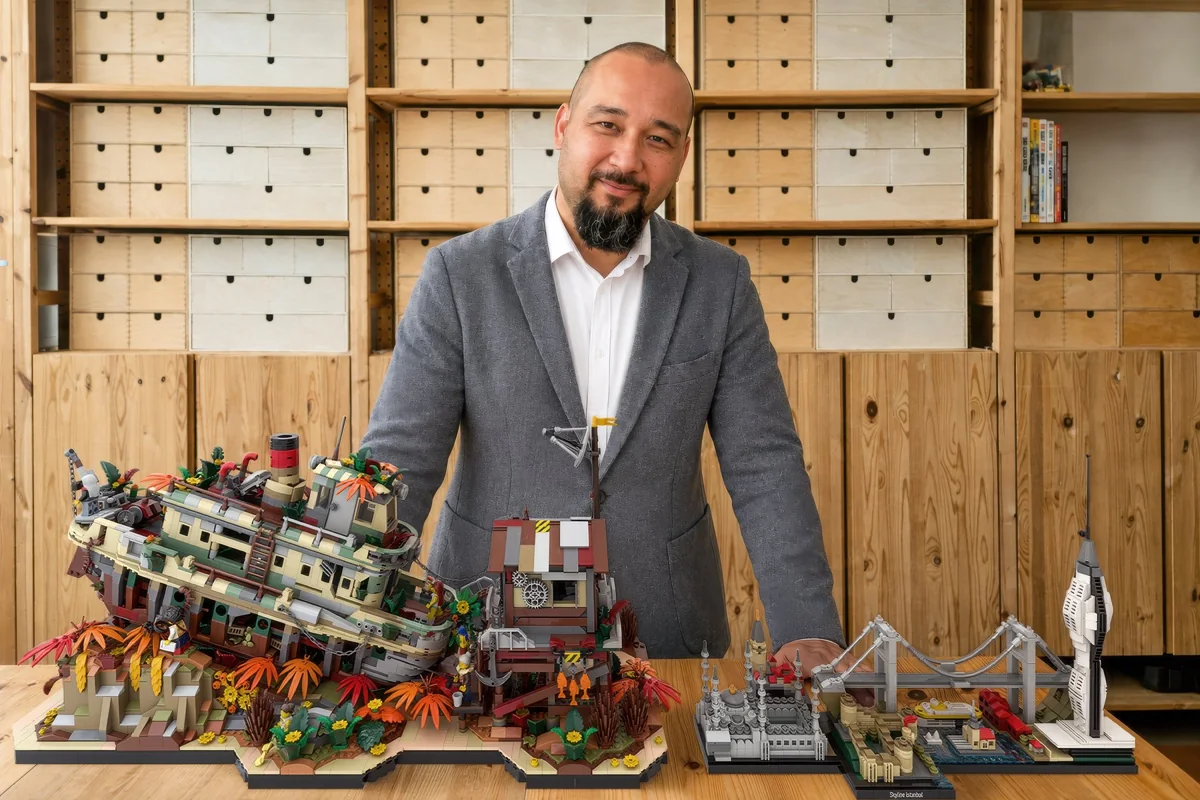 Emmett Sati at the studio bench with The Iron Reef and Skyline Istanbul, in front of the parts wall